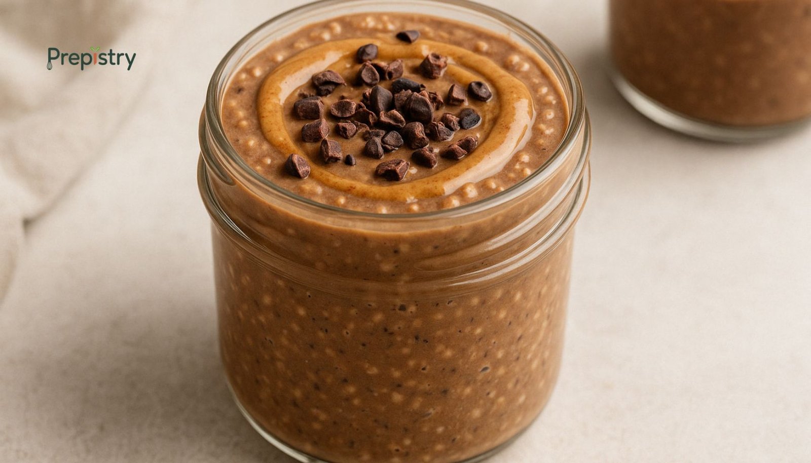 Mocha Banana Overnight Protein Pudding Jar of mocha banana overnight protein pudding topped with almond butter and cacao nibs